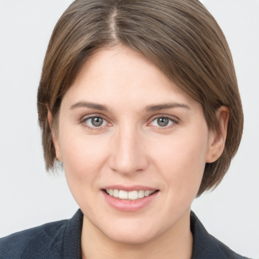 Joyful white young-adult female with medium  brown hair and grey eyes