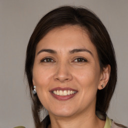 Joyful white adult female with medium  brown hair and brown eyes