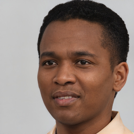 Joyful black young-adult male with short  black hair and brown eyes