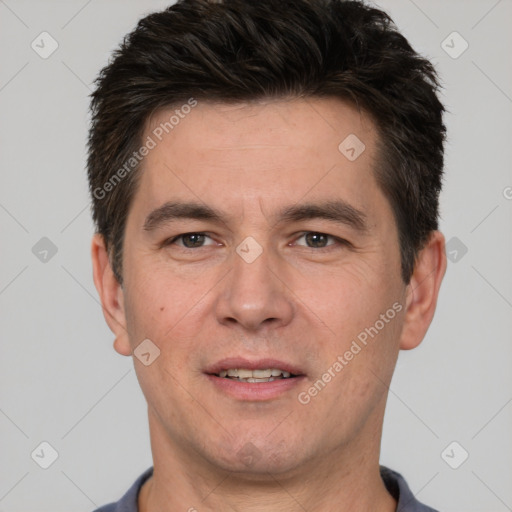 Joyful white adult male with short  brown hair and brown eyes