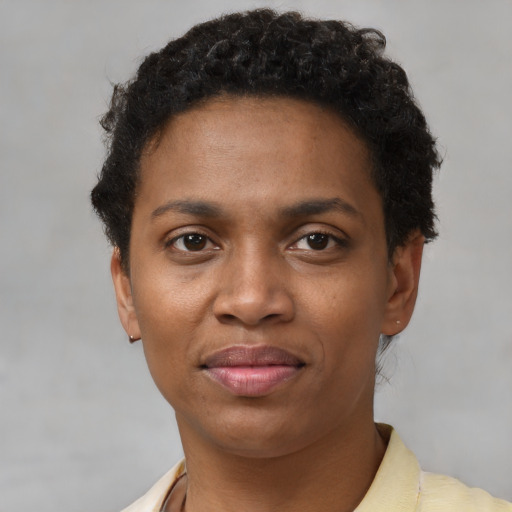 Joyful black young-adult female with short  brown hair and brown eyes