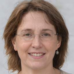 Joyful white adult female with medium  brown hair and grey eyes