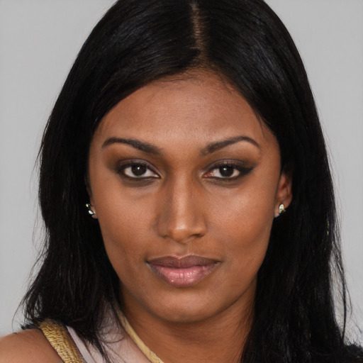 Joyful latino young-adult female with long  brown hair and brown eyes
