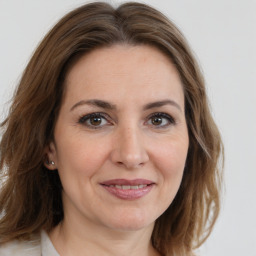 Joyful white adult female with medium  brown hair and brown eyes