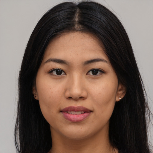 Joyful asian young-adult female with long  brown hair and brown eyes