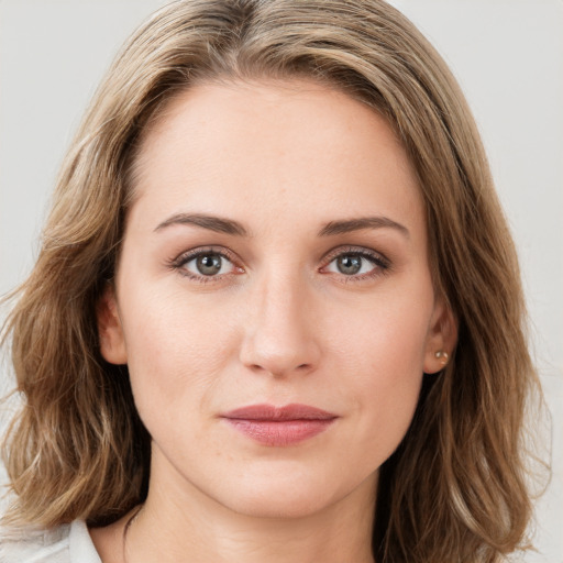 Joyful white young-adult female with medium  brown hair and green eyes