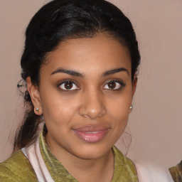 Joyful black young-adult female with medium  brown hair and brown eyes