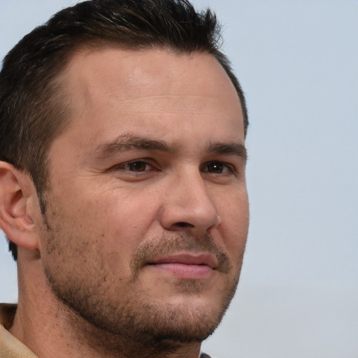 Joyful white adult male with short  brown hair and brown eyes