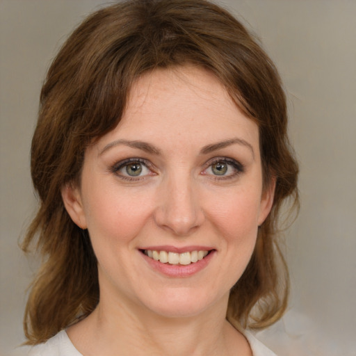 Joyful white young-adult female with medium  brown hair and green eyes