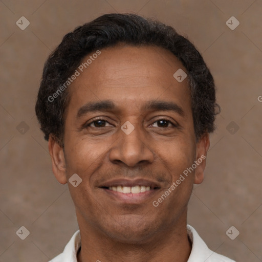 Joyful latino adult male with short  brown hair and brown eyes