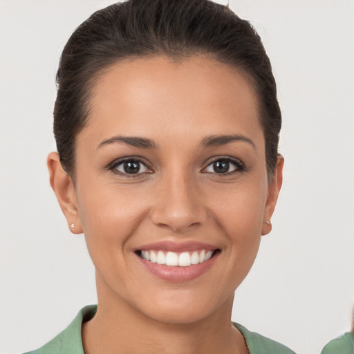 Joyful white young-adult female with short  brown hair and brown eyes