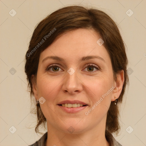 Joyful white adult female with medium  brown hair and green eyes