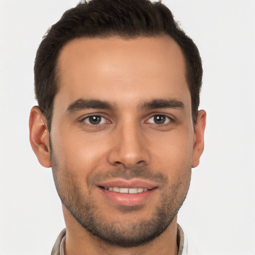 Joyful white young-adult male with short  brown hair and brown eyes