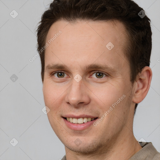 Joyful white young-adult male with short  brown hair and brown eyes