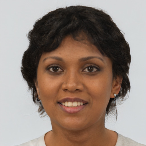 Joyful black young-adult female with medium  brown hair and brown eyes