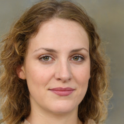 Joyful white young-adult female with medium  brown hair and green eyes