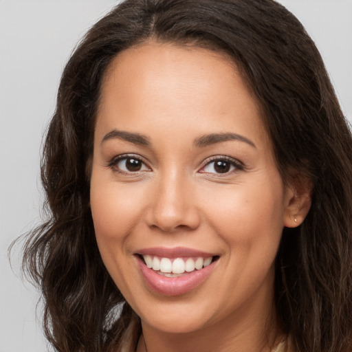 Joyful white young-adult female with long  brown hair and brown eyes