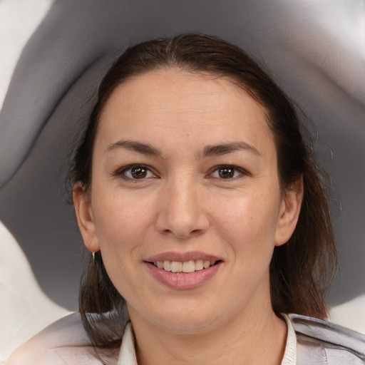 Joyful white adult female with medium  brown hair and brown eyes
