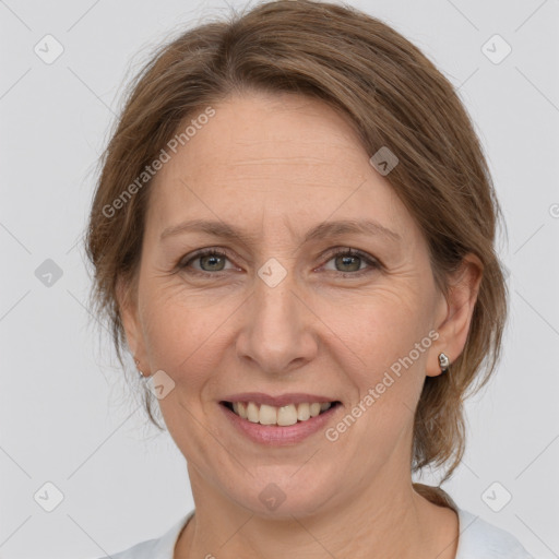 Joyful white adult female with medium  brown hair and grey eyes