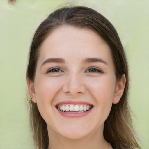 Joyful white young-adult female with long  brown hair and green eyes