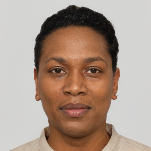 Joyful black young-adult female with short  black hair and brown eyes
