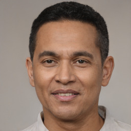Joyful latino adult male with short  black hair and brown eyes