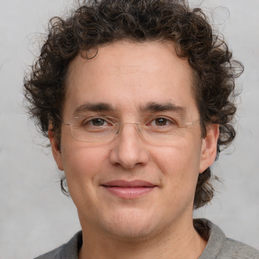 Joyful white adult male with medium  brown hair and brown eyes