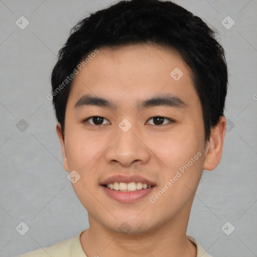 Joyful asian young-adult male with short  black hair and brown eyes