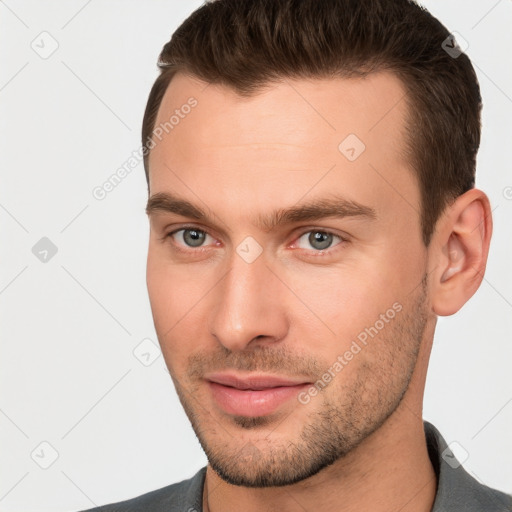 Joyful white young-adult male with short  brown hair and brown eyes