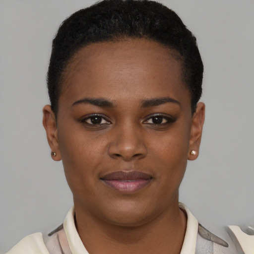 Joyful black young-adult female with short  black hair and brown eyes