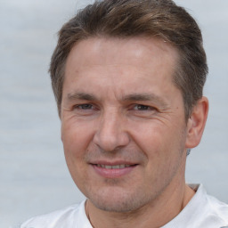 Joyful white adult male with short  brown hair and brown eyes