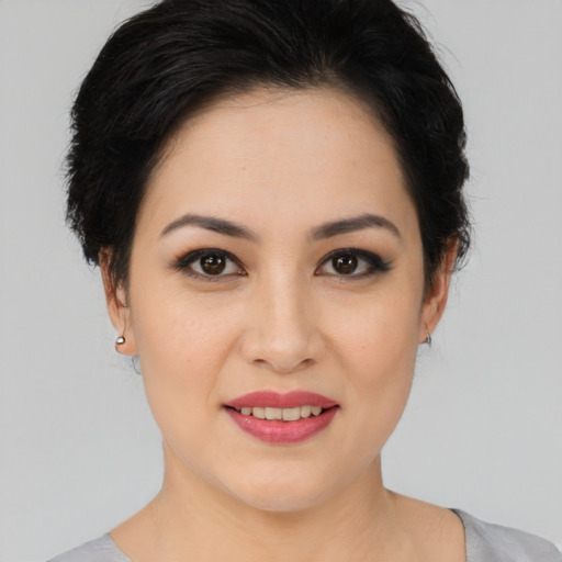 Joyful white young-adult female with medium  black hair and brown eyes