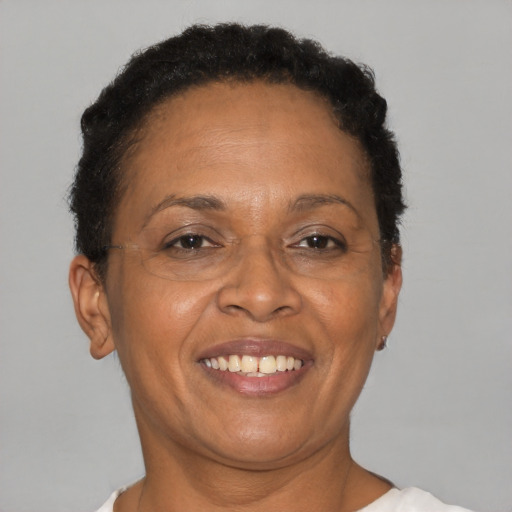 Joyful black adult female with short  brown hair and brown eyes