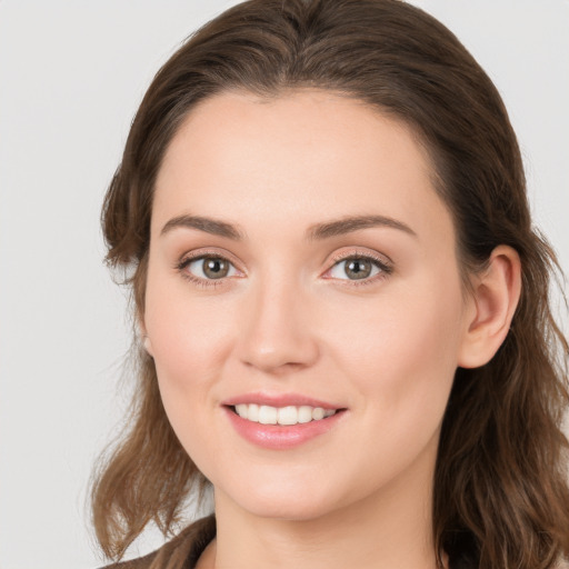 Joyful white young-adult female with long  brown hair and grey eyes