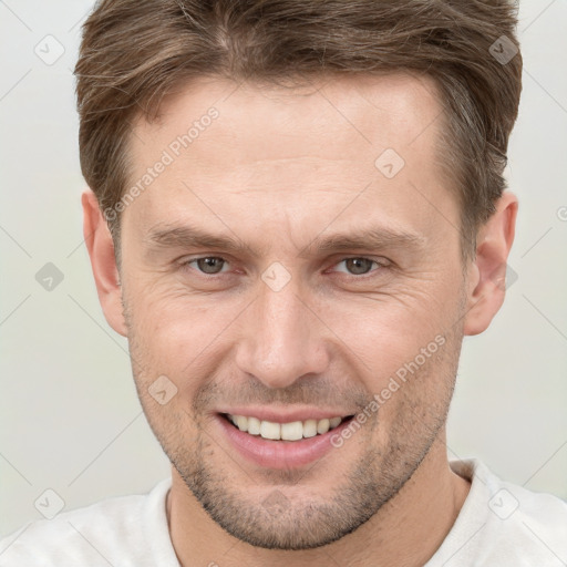 Joyful white adult male with short  brown hair and brown eyes