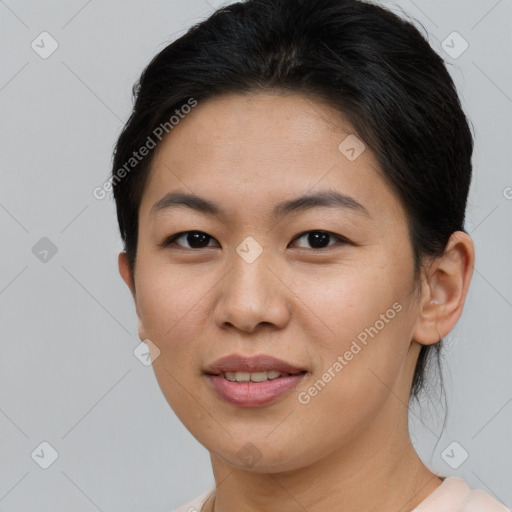 Joyful asian young-adult female with short  brown hair and brown eyes