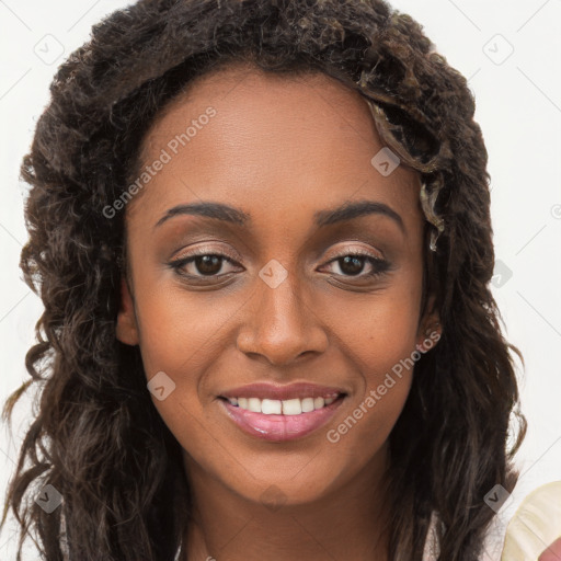 Joyful black young-adult female with long  brown hair and brown eyes