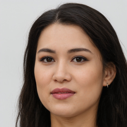 Joyful latino young-adult female with long  brown hair and brown eyes