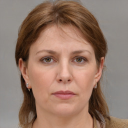 Joyful white adult female with medium  brown hair and grey eyes
