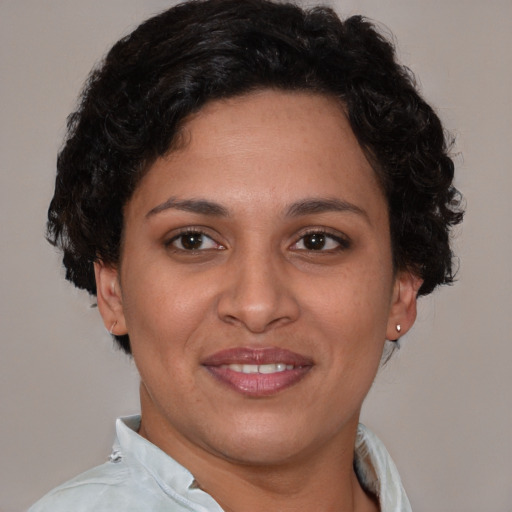 Joyful latino adult female with short  brown hair and brown eyes