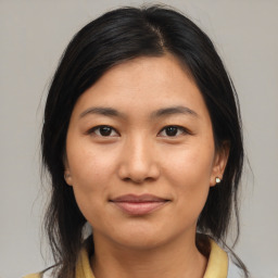 Joyful latino young-adult female with medium  brown hair and brown eyes