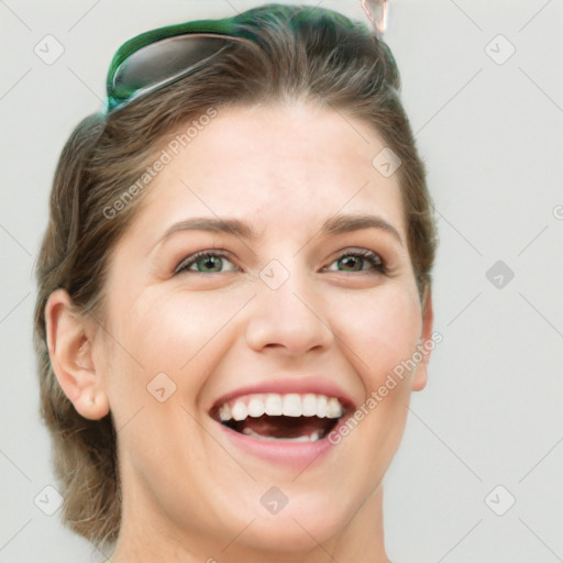 Joyful white young-adult female with medium  brown hair and green eyes