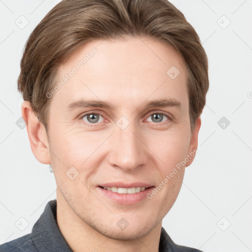 Joyful white young-adult male with short  brown hair and grey eyes