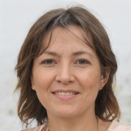 Joyful white adult female with medium  brown hair and brown eyes