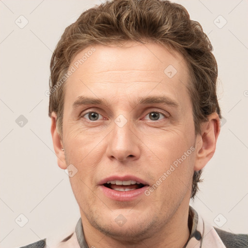 Joyful white adult male with short  brown hair and grey eyes