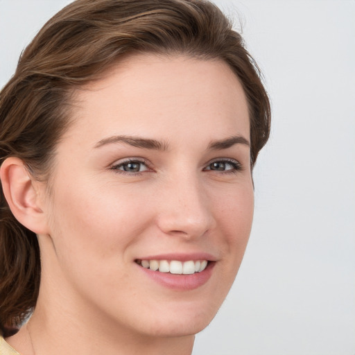 Joyful white young-adult female with medium  brown hair and blue eyes