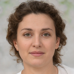 Joyful white young-adult female with medium  brown hair and green eyes