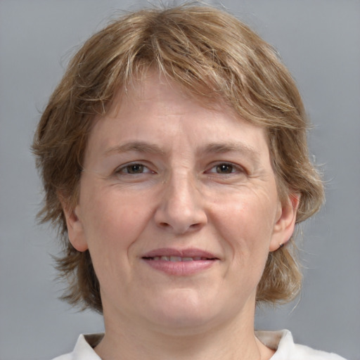 Joyful white adult female with medium  brown hair and grey eyes