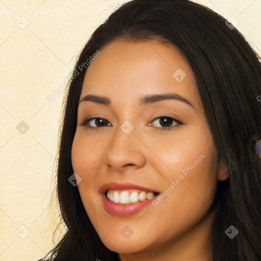 Joyful latino young-adult female with long  brown hair and brown eyes