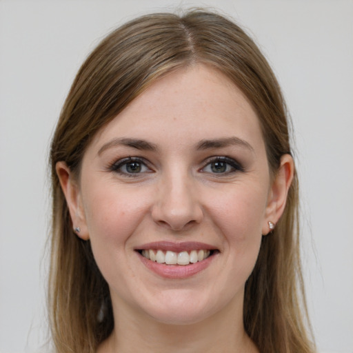 Joyful white young-adult female with long  brown hair and grey eyes